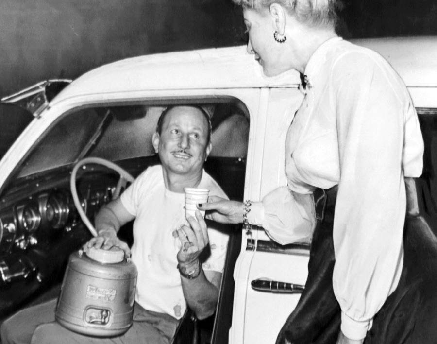 A hot New York City summer as cab driver Harry Newman serves a cup of iced tea to a customer.