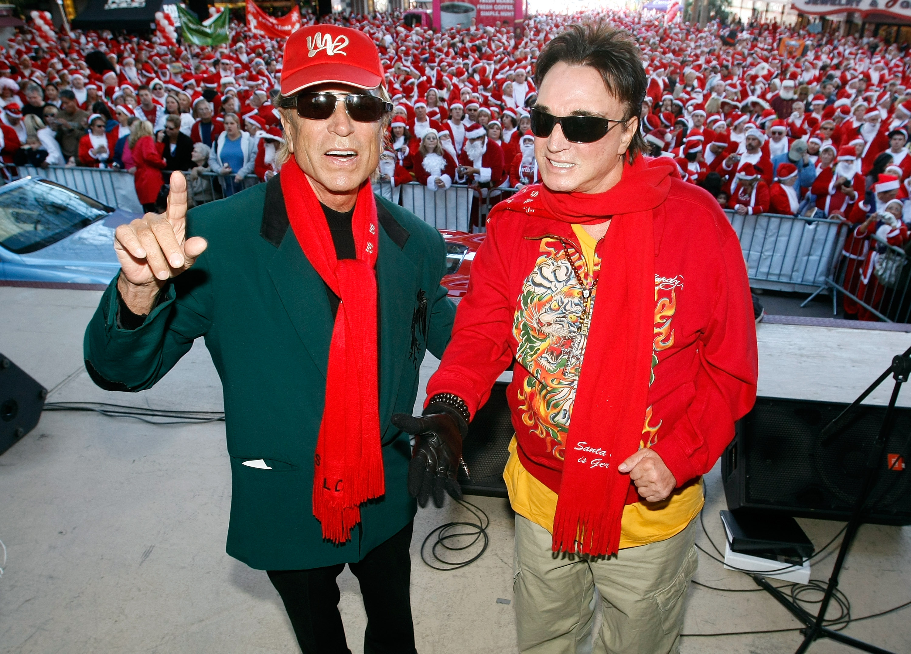 Illusionists Siegfried Fischbacher, left, and Roy Horn pose in front of thousands of runners dressed in Santa Claus outfits before the start of Opportunity Village's fourth annual 5K Las Vegas Great Santa Run on Dec. 6, 2008 in Las Vegas, Nevada.