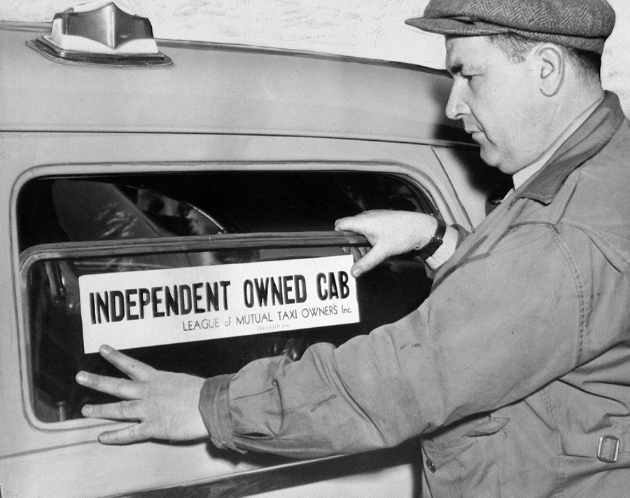 Chubby Greengold sticks sticker on his taxi.