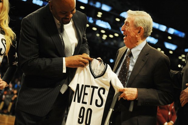 Basketball legend and former Nets coach Lou Carnesecca is honored and presented with a jersey by GM Billy King.