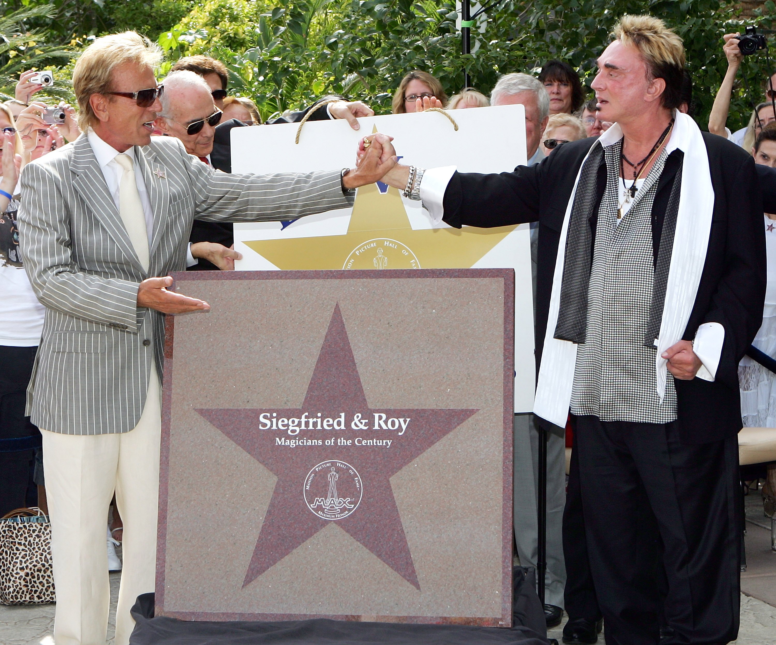 Siegfried Fischbacher, left, and Roy Horn of the illusionist duo Siegfried & Roy pose with their star outside The Mirage Hotel & Casino during the duo's Las Vegas Walk of Stars dedication ceremony on Horn's 62nd birthday on October 3, 2006 in Las Vegas, Nevada.
