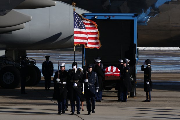 Members of a military honor cordon transfer the flag-draped casket of former US President Jimmy Carter to a hearse during an arrival ceremony in Joint Base Andrews, Maryland, on January 7, 2025. Carter, the 39th President of the United States, died at the age of 100 on December 29, 2024 at his home in Plains, Georgia. (Photo by Samuel Corum / AFP) (Photo by SAMUEL CORUM/AFP via Getty Images)