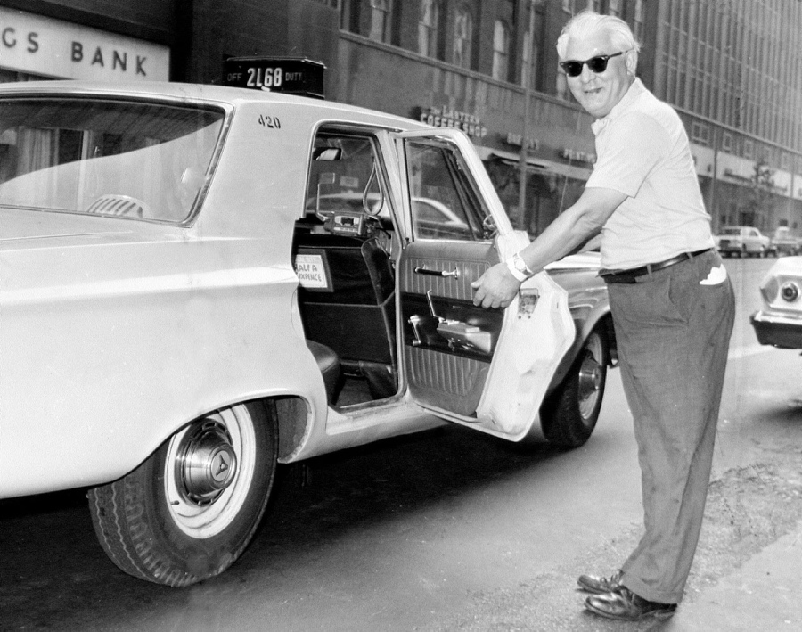 Taxicab driver Ben Macen poses with his car.