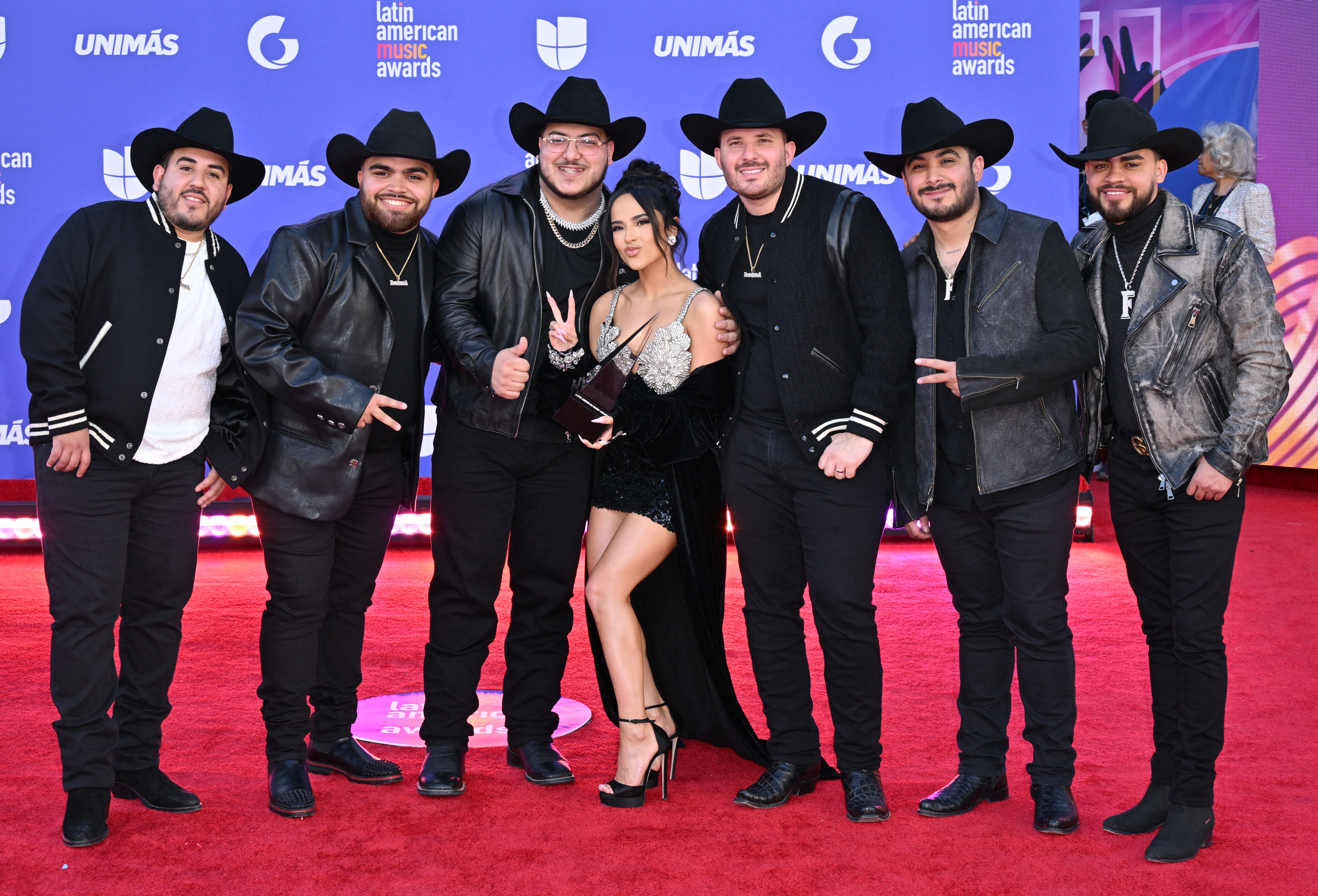 Becky G poses with Grupo Frontera on arrivals for the 8th annual Latin American Music Awards at the MGM Grand Garden Arena in Las Vegas, Nev., on April 20, 2023.