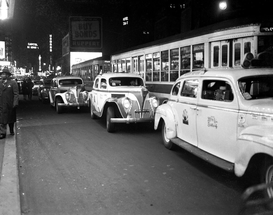 Taxis queue up in Times Square for theater patrons. Take note of the street car in the center lane: surely a faster option than the M42.